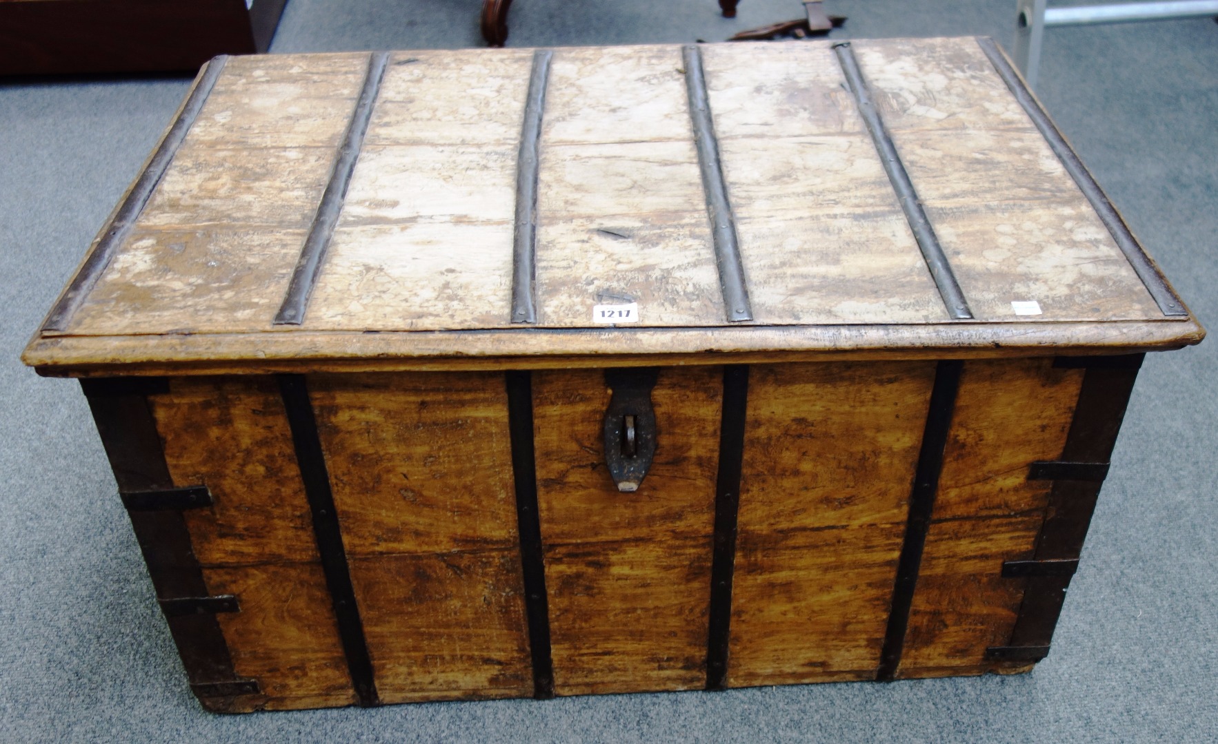 Appraisal: An iron bound teak trunk with side carry handles cm