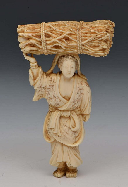 Appraisal: A JAPANESE IVORY OKIMONO lady carrying a bundle of faggots