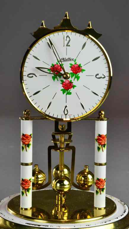 Appraisal: Glass Domed Enamelled Rose Clock by HallerHaving rotating ball pendulum