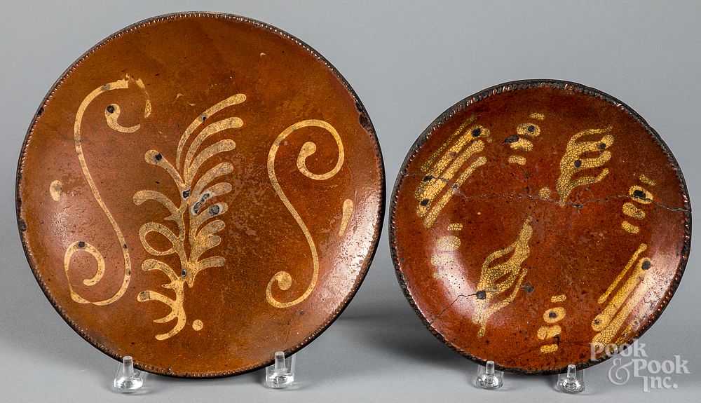 Appraisal: Two slip decorated redware plates Two slip decorated redware plates