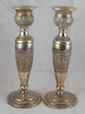 Appraisal: A pair of white metal tests silver candlesticks embossed and