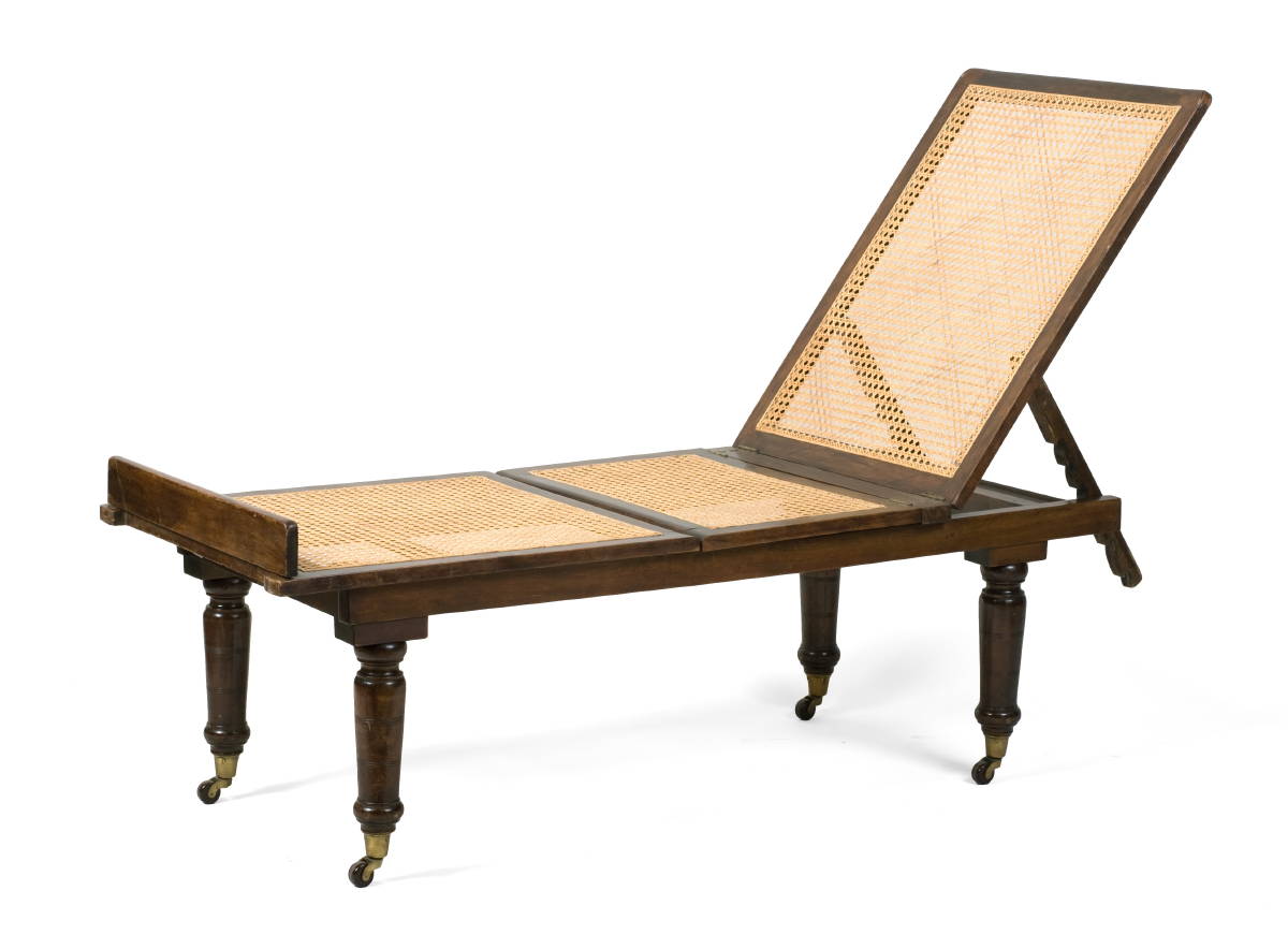 Appraisal: MAHOGANY CAMPAIGN CHAISE LOUNGE The rectangular caned head rest and