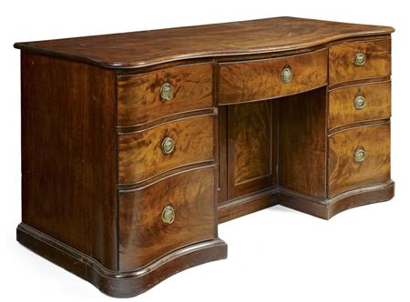 Appraisal: UNUSUAL GEORGE III MAHOGANY SERPENTINE DESK CIRCA the shaped crossbanded