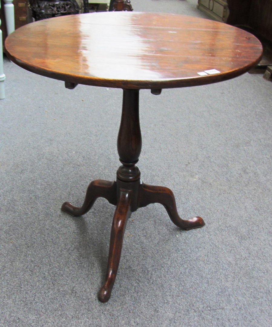 Appraisal: An th century oak circular snap top occasional table on