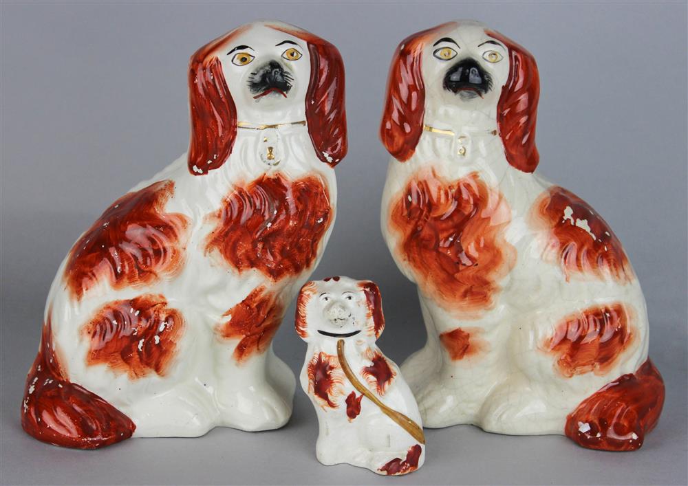 Appraisal: A PAIR OF STAFFORDSHIRE SEATED SPANIELS both impressed with iron