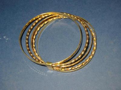 Appraisal: FIVE CT GOLD BANGLES two of twisted form held with