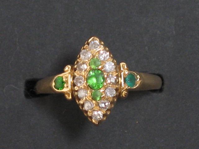 Appraisal: A DIAMOND AND GREEN STONE DRESS RING the marquise frame