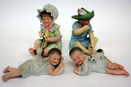 Appraisal: A PAIR OF BISQUE PORCELAIN PIANO DOLLS of reclining children