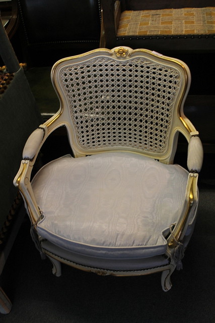 Appraisal: A FRENCH STYLE PAINTED OPEN ARMCHAIR with cane back and