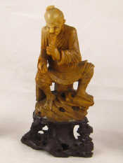 Appraisal: A finely carved Chinese hardstone figure of a seated man