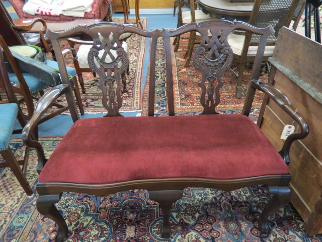 Appraisal: Mahogany Settee Chippendale style ball and claw feet red velvet