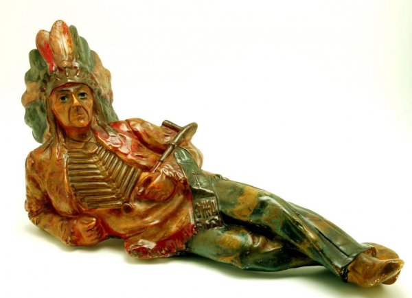 Appraisal: Polychrome plaster figure of a recumbent Sioux Indian in war