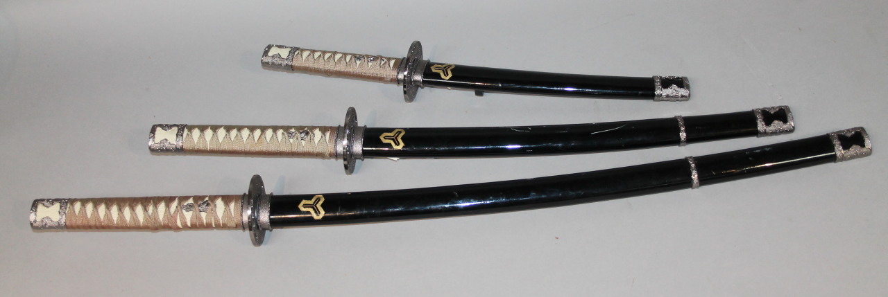 Appraisal: Three modern graduated Japanese samurai swords each with curved gilt