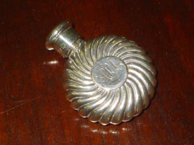 Appraisal: A VICTORIAN SCENT BOTTLE of flat circular form chased with