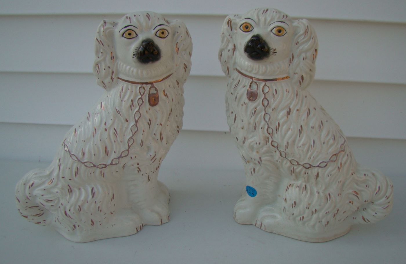 Appraisal: PAIR OF STAFFORDSHIRE POTTERY SPANIELS th CenturyWhite bodies with pink