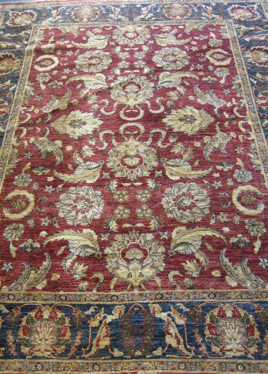 Appraisal: Modern red ground Eastern carpet with a main blue border