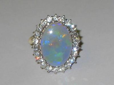 Appraisal: AN OPAL AND DIAMOND DRESS RING the oval polished opal