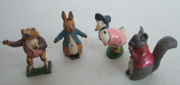 Appraisal: Four hollow cast painted advertising figures from the Beatrix Potter