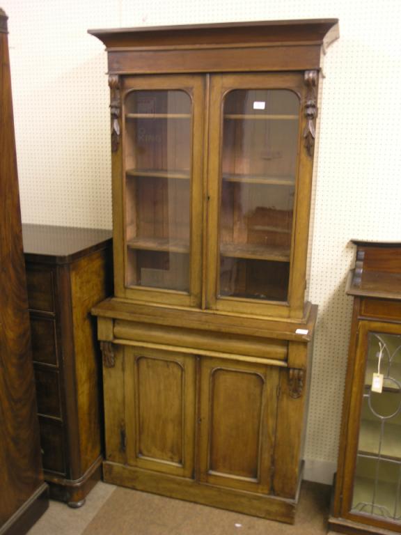 Appraisal: A Victorian mahogany tall bookcase upper section with carved corbels