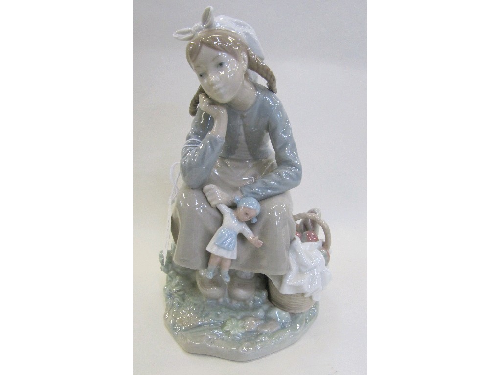 Appraisal: Lladro figure of a seated girl holding a doll