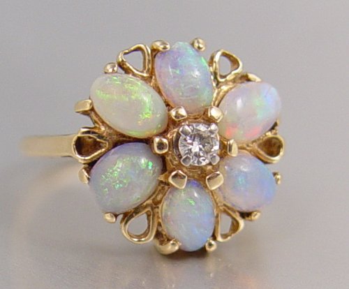 Appraisal: K OPAL AND DIAMOND RING K yellow gold ring contains