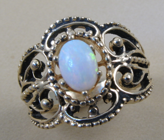 Appraisal: OPAL AND TEN KARAT GOLD RING centered and secured by