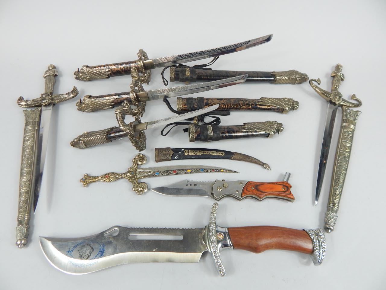 Appraisal: A collection of small elaborately carved fantasy style daggers with