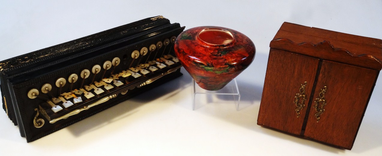 Appraisal: An early thC ebonised squeeze box with mother-of-pearl finish buttons