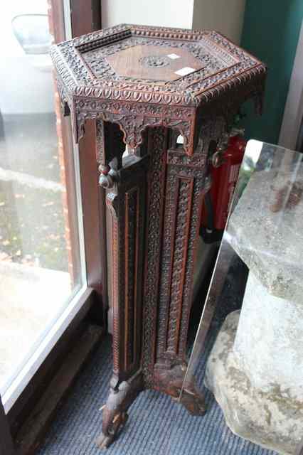 Appraisal: AN ORIENTAL ROSEWOOD JARDINERE STAND with floral carved hexagonal top