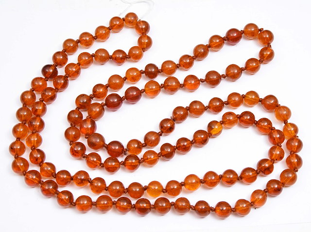 Appraisal: A CHINESE LONG AMBER BEAD NECKLACE approximately cm long grams