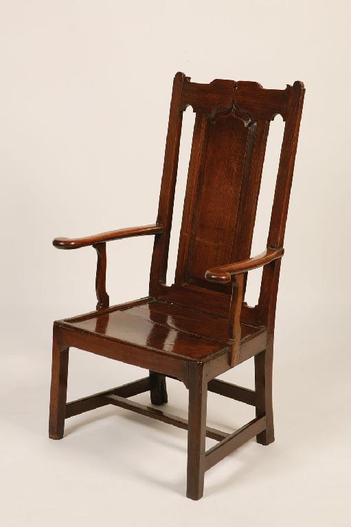 Appraisal: A GEORGE III WELSH OAK ARMCHAIR the tall back with