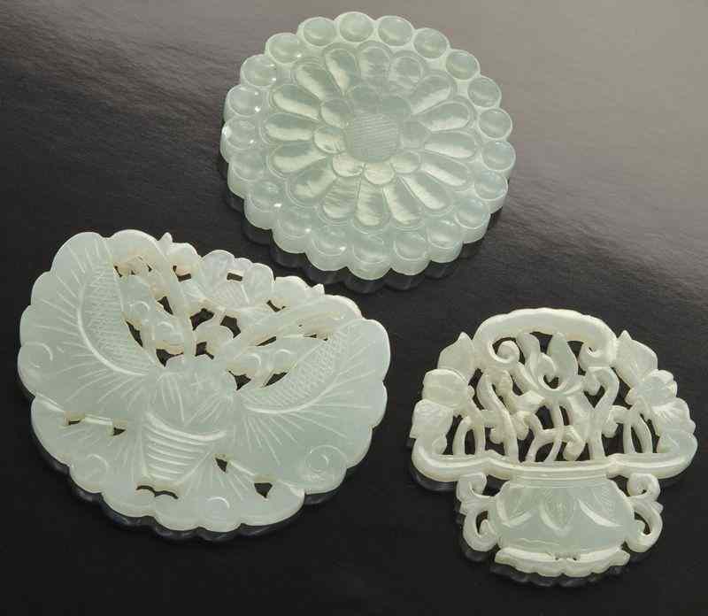 Appraisal: Chinese Qing carved jade plaquesdepicting butterflies baskets and chrysanthemum Largest