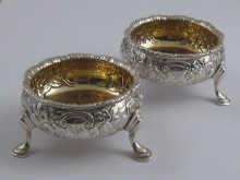 Appraisal: A pair of Georgian embossed silver cauldron salts probably Jacob