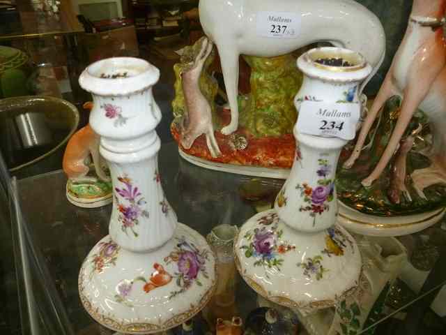 Appraisal: A PAIR OF DRESDEN PORCELAIN CANDLESTICKS painted with floral designs