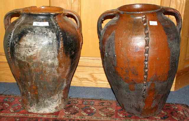 Appraisal: A PAIR OF OLD BROWN GLAZED TWO HANDLED WINE JARS