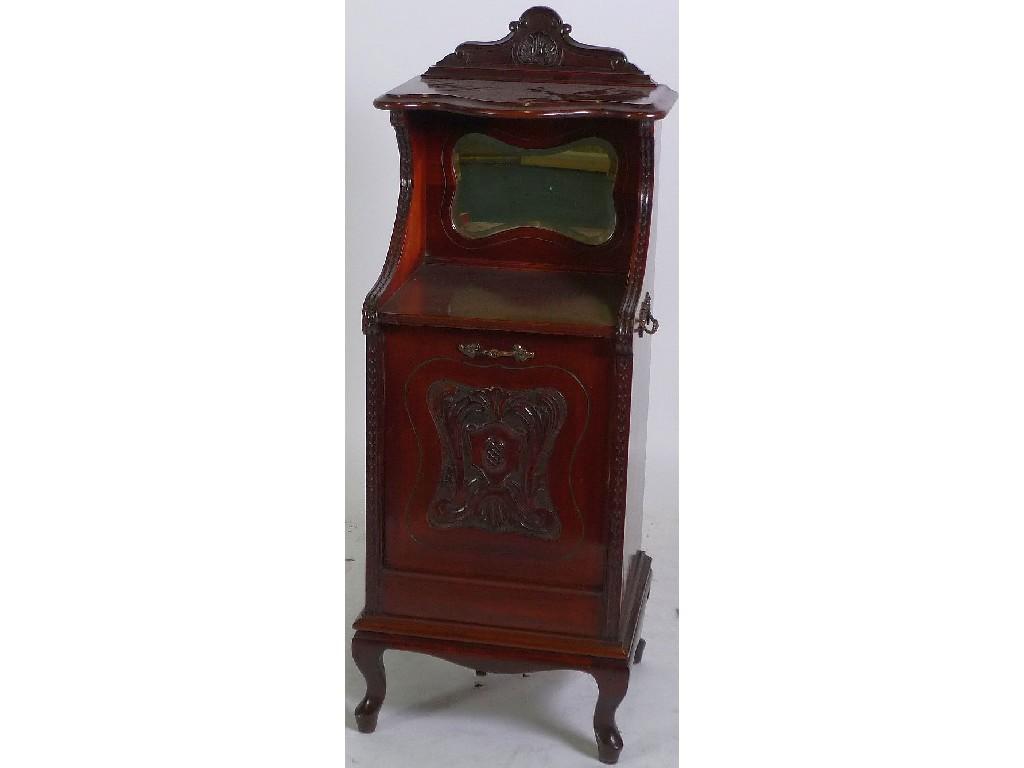 Appraisal: EARLY TWENTIETH CENTURY CARVED MAHOGANY COAL PURDONIUM the serpentine fronted