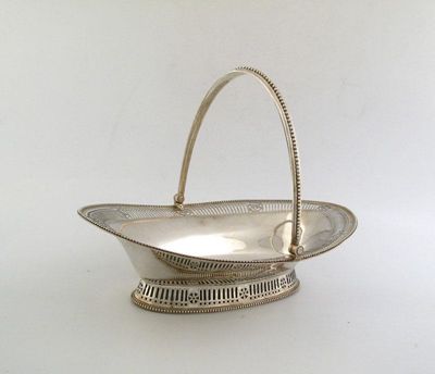 Appraisal: A George III pierced oval cake basket heightened with engraved