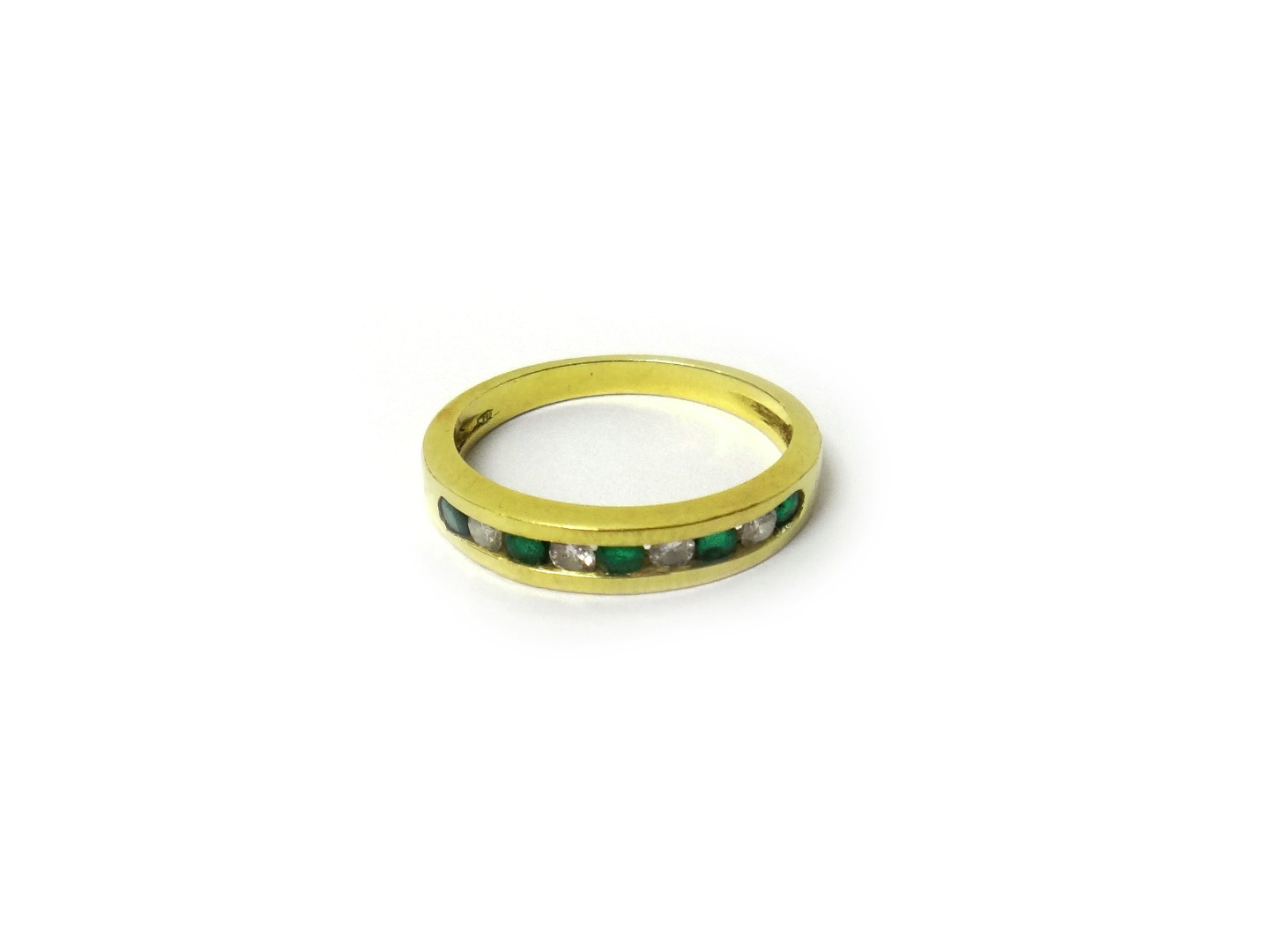 Appraisal: A gold emerald and diamond half hoop ring mounted with