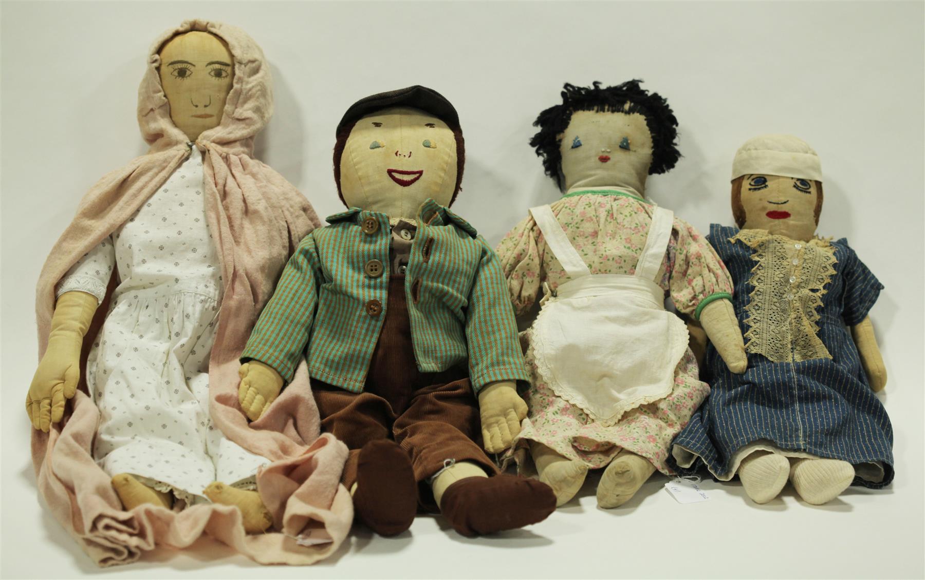 Appraisal: FOUR CLOTH DOLLS WITH STITCHED FEATURES American late th-early th