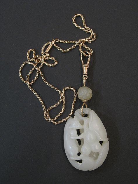 Appraisal: AN OPEN CARVED OVAL MUTTON JADE PENDANT with a carved