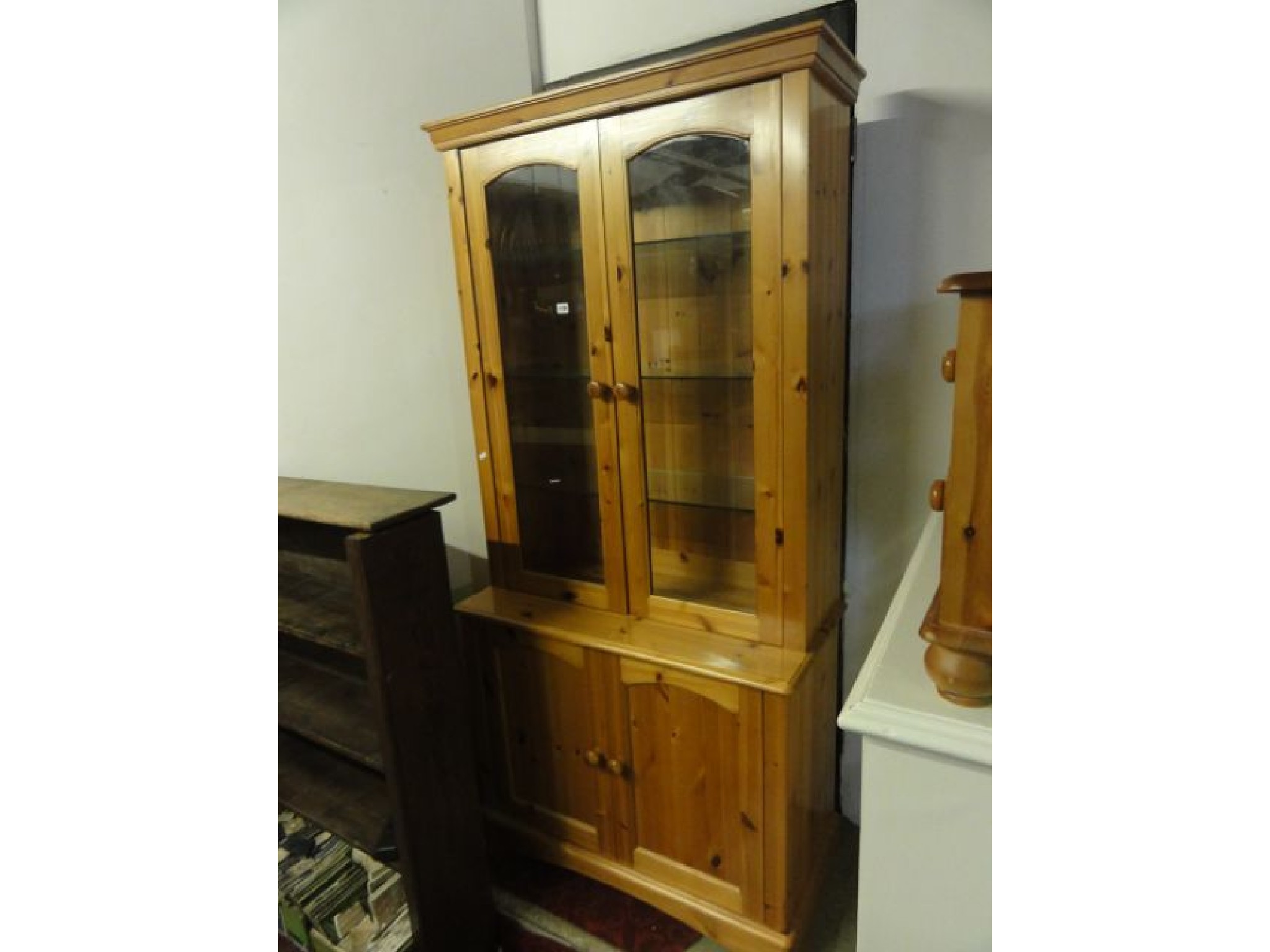 Appraisal: A contemporary pine freestanding dresser display cabinet the upper recessed