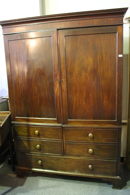 Appraisal: A TH CENTURY MAHOGANY CAMPAIGN WARDROBE the front having plain