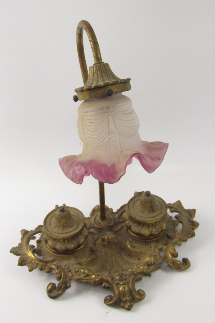 Appraisal: An early thC rococo design lamp and inkwell the shaped