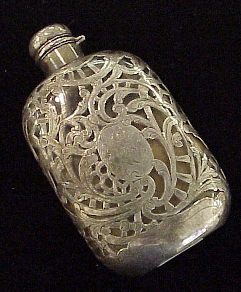 Appraisal: Silver overlay clear glass flask with hinged cap monogrammed and