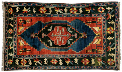 Appraisal: Modern Turkish rug multiple blue olive and salmon central medallions