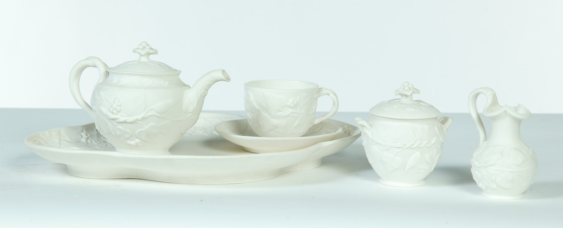 Appraisal: FIVE-PIECE PARIAN RELIEF MOLDED TEA SET England mid th century