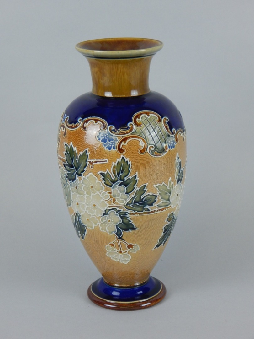 Appraisal: A Royal Doulton stoneware vase decorated with flowers and leaves