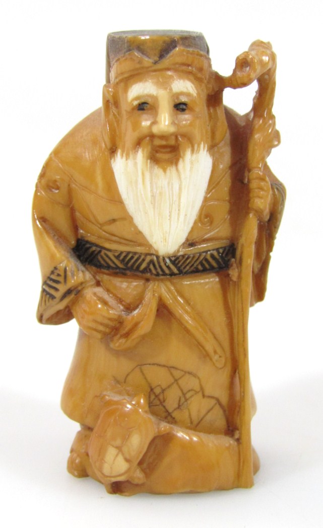 Appraisal: A Japanese netsuke formed as a bearded sage holding staff