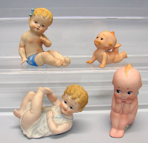 Appraisal: Lot of bisque figurines Piano Baby type toddlers Kewpie type