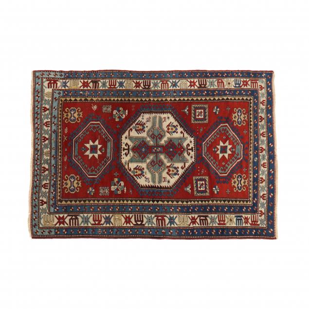 Appraisal: CAUCASIAN AREA RUG Red field with ivory octagonal medallion with